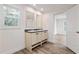 Well-lit bathroom featuring a double vanity, wood-look flooring, and a window at 3772 Green Sea Rd., Green Sea, SC 29545
