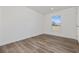 Bright bedroom with laminate floors, base trim and a view from the light-filled window at 3772 Green Sea Rd., Green Sea, SC 29545