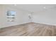Bright bedroom with hardwood floors and natural light from two windows at 3772 Green Sea Rd., Green Sea, SC 29545