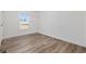 Sunlit bedroom features laminate floors, white trim and a view from bright window at 3772 Green Sea Rd., Green Sea, SC 29545