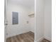 Utility room with a shelf, white walls and light-colored wood floor at 3772 Green Sea Rd., Green Sea, SC 29545