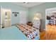 Comfortable bedroom features a decorative quilt, hardwood floors and access to a private bathroom at 3926 Flagg St., Murrells Inlet, SC 29576