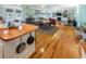 Open-concept living room with hardwood floors, a fireplace, and a dining area adjacent to the kitchen at 3926 Flagg St., Murrells Inlet, SC 29576