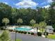 An aerial view showcases the sparkling community pool surrounded by palm trees and a wooded landscape at 398 Blue Stem Dr. # 59E, Pawleys Island, SC 29585
