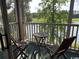 Balcony with a small table and chairs overlooking a lake and golf course at 398 Blue Stem Dr. # 59E, Pawleys Island, SC 29585