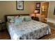 Comfortable bedroom with hardwood floors, light blue pillows, and access to the ensuite bathroom at 398 Blue Stem Dr. # 59E, Pawleys Island, SC 29585