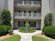 A building exterior showcases charming balconies, neat landscaping, and a welcoming entryway at 398 Blue Stem Dr. # 59E, Pawleys Island, SC 29585
