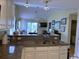 Open kitchen with granite counters and tiled floor and connected to the living room and outdoor balcony at 398 Blue Stem Dr. # 59E, Pawleys Island, SC 29585