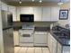 Well-lit kitchen featuring stainless steel appliances, white cabinets, and granite countertops at 398 Blue Stem Dr. # 59E, Pawleys Island, SC 29585