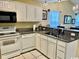 Bright kitchen with stainless steel appliances, white cabinetry, and granite countertops, perfect for cooking at 398 Blue Stem Dr. # 59E, Pawleys Island, SC 29585