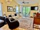 Living room featuring a cozy sofa, chandelier, ceiling fan and sliding glass doors to the outdoor balcony at 398 Blue Stem Dr. # 59E, Pawleys Island, SC 29585