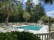Exterior shot showcasing a well-maintained community pool surrounded by chairs and lush greenery at 398 Blue Stem Dr. # 59E, Pawleys Island, SC 29585