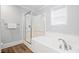 Well-lit bathroom with a combination shower and tub, tiled surround, and a window providing natural light at 400 Hillside Dr. S, North Myrtle Beach, SC 29582