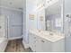 A blue bathroom with double sink vanity, shower, and well-lit mirror at 400 Hillside Dr. S, North Myrtle Beach, SC 29582
