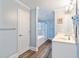 Large bathroom with a double vanity, a door to a separate room, and a bathtub with shower behind glass at 400 Hillside Dr. S, North Myrtle Beach, SC 29582
