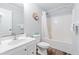 Bright bathroom featuring a shower-tub combo with a white curtain, white vanity, and toilet at 400 Hillside Dr. S, North Myrtle Beach, SC 29582