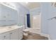Cozy bathroom includes a white vanity, toilet, and shower/tub combo with a stylish blue shower curtain at 400 Hillside Dr. S, North Myrtle Beach, SC 29582