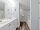 Bright bathroom featuring a double vanity, modern fixtures, and a glass-enclosed shower-tub combination at 400 Hillside Dr. S, North Myrtle Beach, SC 29582