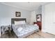 Comfortable bedroom with a plush bed, bedside table and a dark wood dresser with a mirror at 400 Hillside Dr. S, North Myrtle Beach, SC 29582