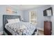 Bright bedroom featuring a comfortable bed, a window with blinds, and a mounted television at 400 Hillside Dr. S, North Myrtle Beach, SC 29582