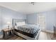 Well-lit bedroom featuring a comfortable bed, small side table, and a glass door to the exterior at 400 Hillside Dr. S, North Myrtle Beach, SC 29582
