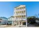 Inviting three-story beach house featuring private balconies and ground-level parking at 400 Hillside Dr. S, North Myrtle Beach, SC 29582