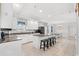 Bright kitchen featuring white cabinetry, granite countertops, an island with seating, and dining area at 400 Hillside Dr. S, North Myrtle Beach, SC 29582