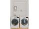 Functional laundry room equipped with a side-by-side washer and dryer, and shelving for storage at 400 Hillside Dr. S, North Myrtle Beach, SC 29582