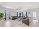 Spacious living room with comfortable leather sofas, ceiling fan, and ample natural light at 400 Hillside Dr. S, North Myrtle Beach, SC 29582