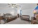 Bedroom features a bed with floral comforter, wood bench and furniture, and a ceiling fan at 412 Carolina Dr., Loris, SC 29569