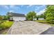 Long concrete driveway leading to a home with a 2-car garage, large yard and many green trees at 412 Carolina Dr., Loris, SC 29569