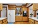 Functional kitchen boasting wood cabinets, built-in appliances, and ample counter space for meal preparation at 412 Carolina Dr., Loris, SC 29569