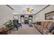 Cozy living room with carpeted floors, traditional furnishings, and natural light streaming through the windows at 412 Carolina Dr., Loris, SC 29569