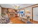 Comfortable living room showcasing a brick fireplace, hardwood floors, and open access to the breakfast nook at 412 Carolina Dr., Loris, SC 29569