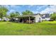 Outbuilding on a grassy lot, covered area for equipment, hay, grill, trailer and black pickup at 412 Carolina Dr., Loris, SC 29569