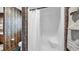 Bathroom shower featuring a white shower curtain, integrated seat, and patterned wallpaper at 412 Carolina Dr., Loris, SC 29569
