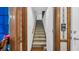 Stairwell leads to the upper level with carpeted steps and wood handrail, plus decorative wallpaper at 412 Carolina Dr., Loris, SC 29569