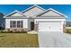 Charming single-Gathering home with a two-car garage, tidy landscaping, and a welcoming front entrance at 427 Lifestyle Court, Surfside Beach, SC 29575