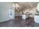 Open concept living space with hardwood floors, modern kitchen, and access to an outdoor patio at 427 Lifestyle Court, Surfside Beach, SC 29575