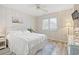 Cozy bedroom with a ceiling fan, light walls, a patterned rug, and natural light at 435 Ocean Creek Dr. # 2722, Myrtle Beach, SC 29572