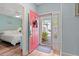 Bright entryway featuring a vivid red door and hardwood floors, with view into the main bedroom at 435 Ocean Creek Dr. # 2722, Myrtle Beach, SC 29572