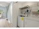 Convenient laundry room features a full-size washer and dryer, plus shelving for storage at 435 Ocean Creek Dr. # 2722, Myrtle Beach, SC 29572