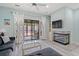 Airy living space with a modern fireplace, built-in shelving, and access to the screened in patio at 435 Ocean Creek Dr. # 2722, Myrtle Beach, SC 29572