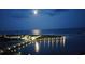 Stunning night view of the intercoastal waterway with a lighted pier extending into the water at 435 Ocean Creek Dr. # 2722, Myrtle Beach, SC 29572