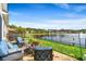 A patio with seating overlooks a serene lake view, complete with a decorative black metal fence at 455 Hyacinth Loop, Murrells Inlet, SC 29576