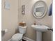 Powder room with vanity, toilet and beach-themed decor and framed mirror at 455 Hyacinth Loop, Murrells Inlet, SC 29576