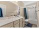 Bright bathroom featuring white cabinetry, marble countertops and tiled floors at 455 Hyacinth Loop, Murrells Inlet, SC 29576