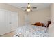 Bedroom with neutral walls and carpet with ceiling fan and double door closet at 455 Hyacinth Loop, Murrells Inlet, SC 29576