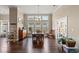 Bright dining room features large windows, hardwood floors, and chandelier lighting at 455 Hyacinth Loop, Murrells Inlet, SC 29576