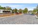 Wide angle view of the stone sign at the paved entry to Lakeshore at 455 Hyacinth Loop, Murrells Inlet, SC 29576